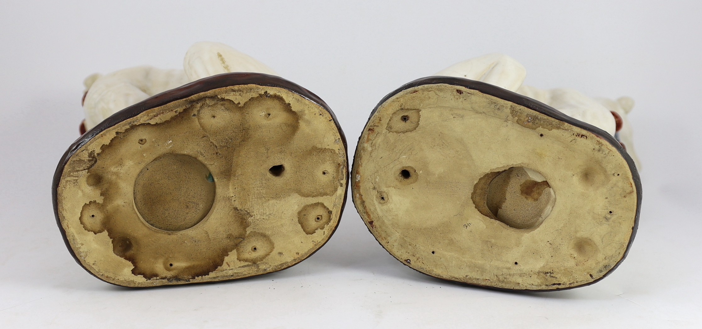 A pair of Italian tin-glaze earthenware figures of seated greyhounds, 35cm high